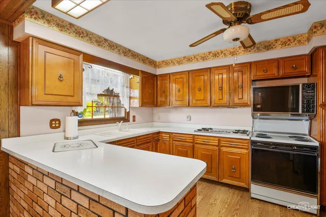 a kitchen with a sink appliances and cabinets