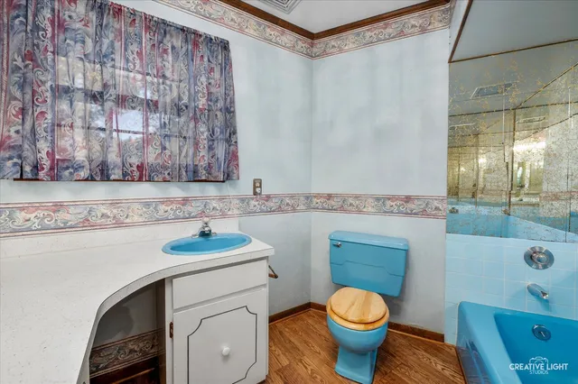 a bathroom with a granite countertop toilet sink and mirror