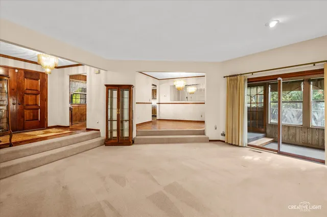 an empty room with entrance and windows