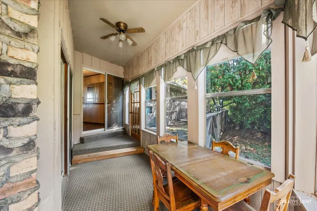 a view of an entryway with a table and chairs