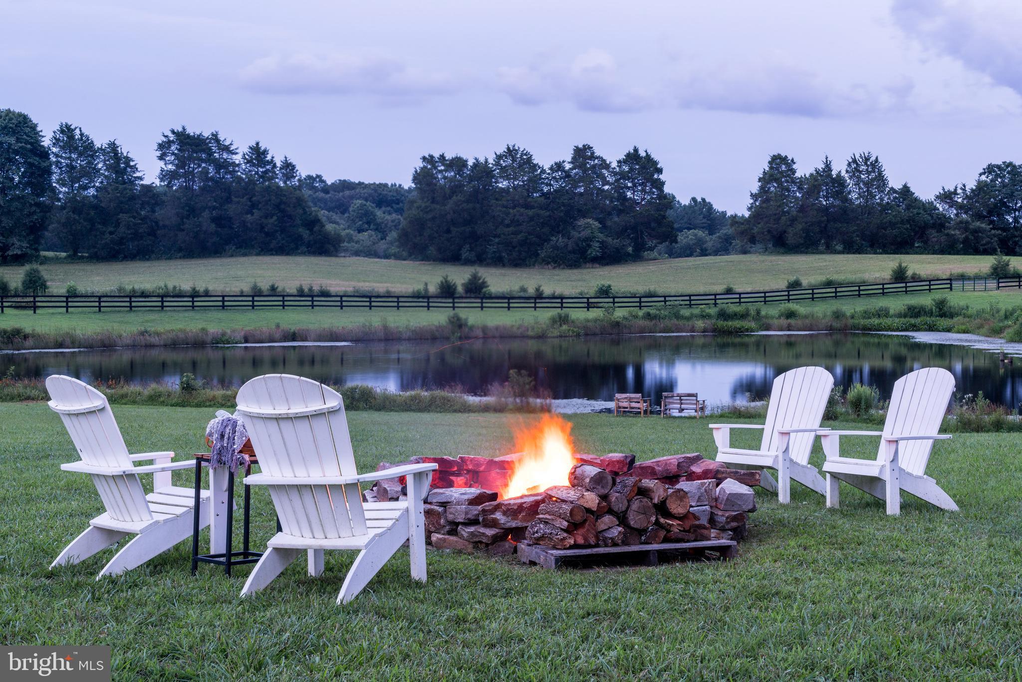 17440 True Blue Lane Reva, VA 22735 - Photo 68 of 75 a view of a lake with a table and chairs