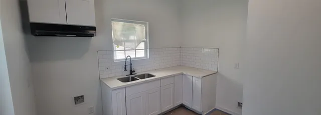 a kitchen with a sink and cabinets
