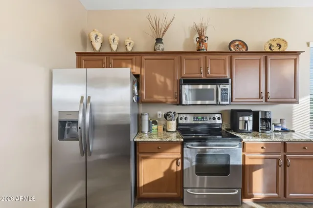 a view of a patio with a table chairs and a grill