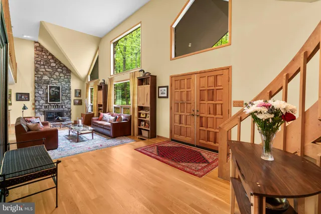 a kitchen with granite countertop a stove oven and white cabinets with wooden floor