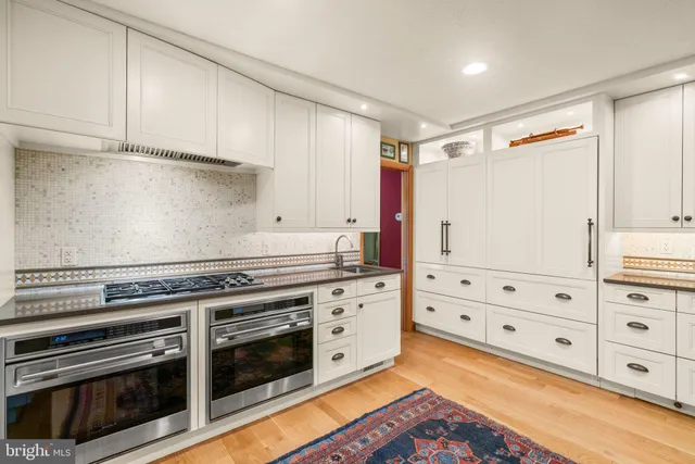 a bed sitting in a spacious bedroom next to a window