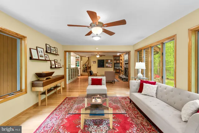 a bedroom with furniture and a large window