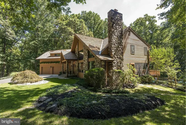 a view of a dining room with furniture wooden floor and a chandelier