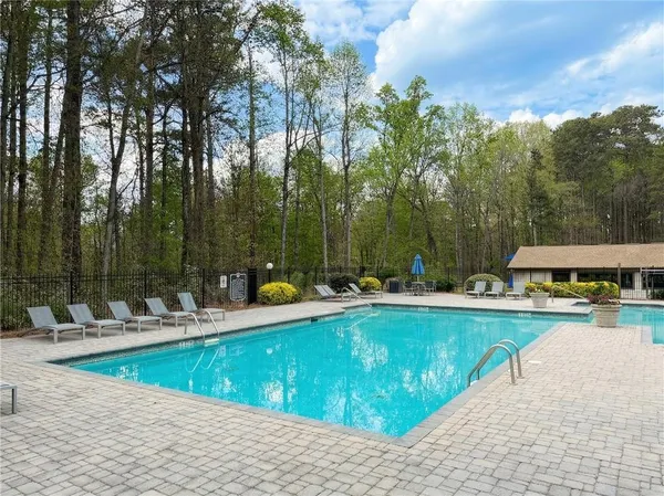 a view of a swimming pool with chairs