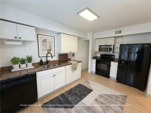 a large kitchen with a refrigerator sink and stove