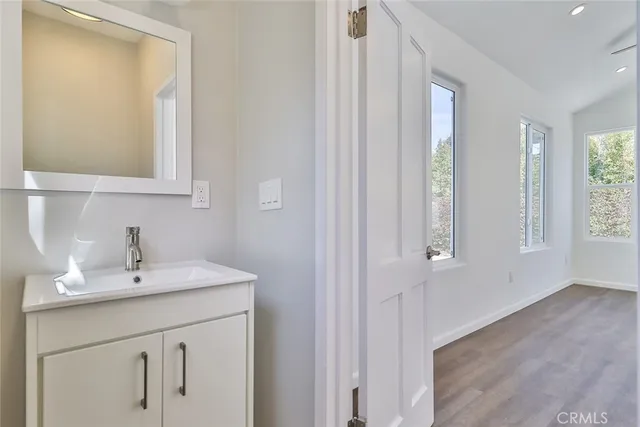 a bathroom with a sink a vanity and a mirror