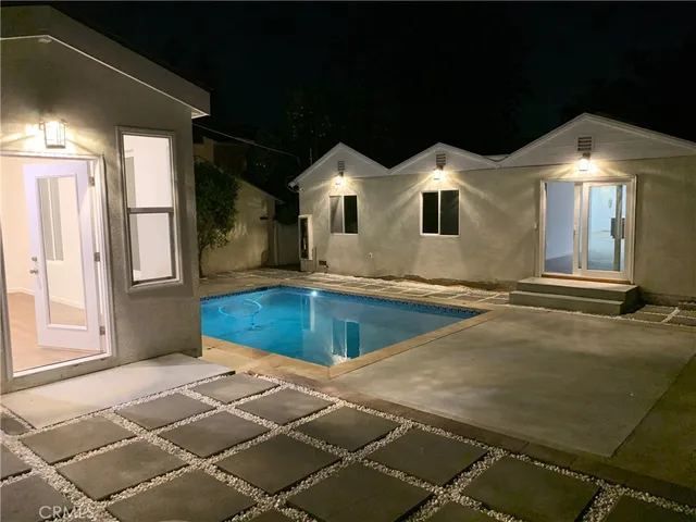 a view of a house with a backyard