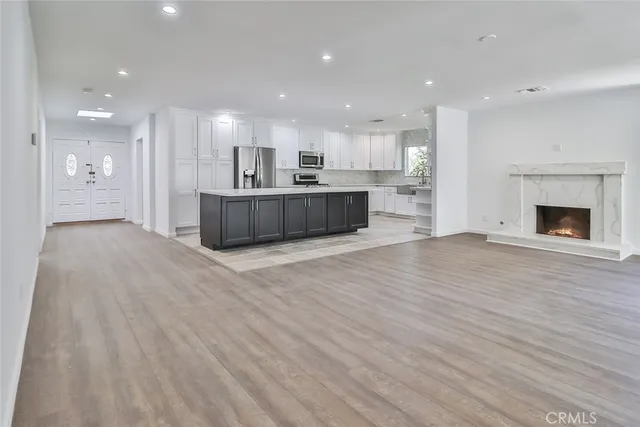a view of kitchen and kitchen with furniture wooden floor