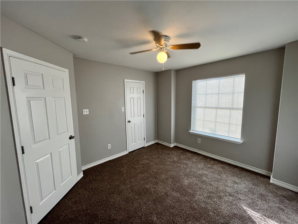 908 East Hefferman Street Beeville, TX 78102 - Photo 37 of 40 an empty room with windows and fan