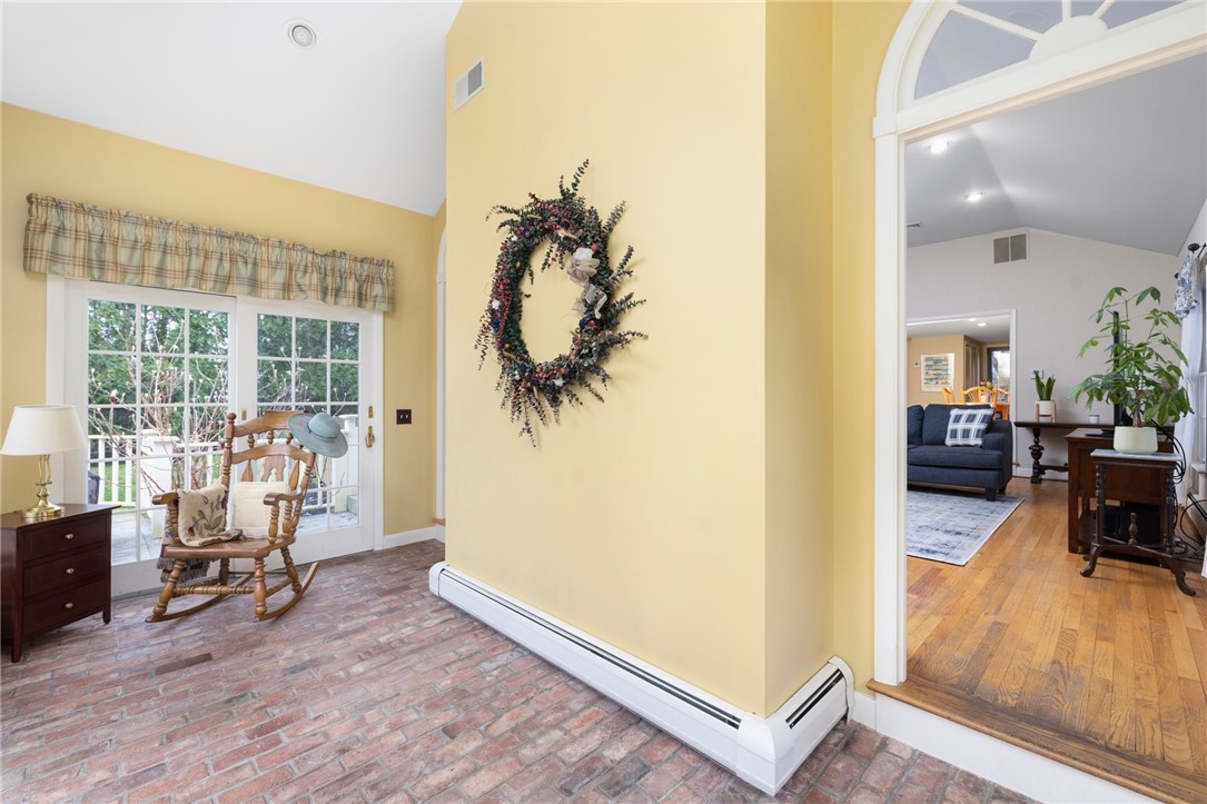 2 Lansdowne Road Warwick, RI 02888 - Photo 16 of 49 The sunroom features a brick floor as well as multiple glass doors that lead to a deck. Baseboard heat warms this room in colder seasons.