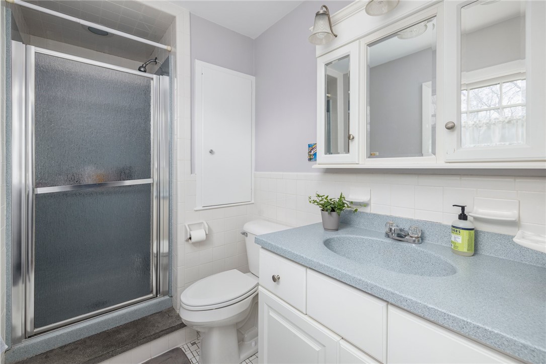 2 Lansdowne Road Warwick, RI 02888 - Photo 30 of 49 The full bathroom in the second primary bedroom is updated and neutral in color.