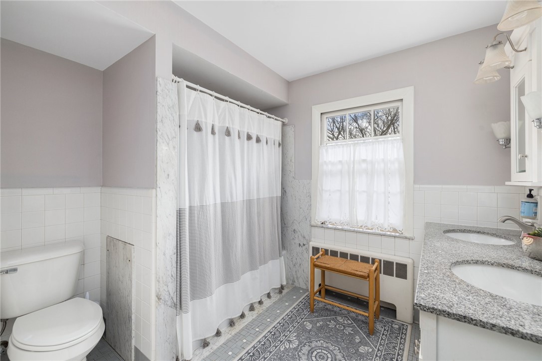 2 Lansdowne Road Warwick, RI 02888 - Photo 32 of 49 The primary bathroom is accessible from the bedroom and hallway and offers double sinks and a full tub.