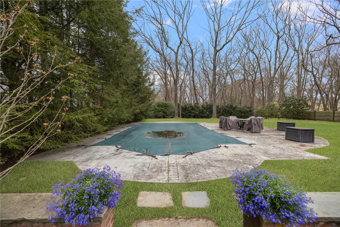 2 Lansdowne Road Warwick, RI 02888 - Photo 45 of 49 The pool is surrounded by mature evergreens. A stamped concrete pool deck has ample space for multiple patio sets.