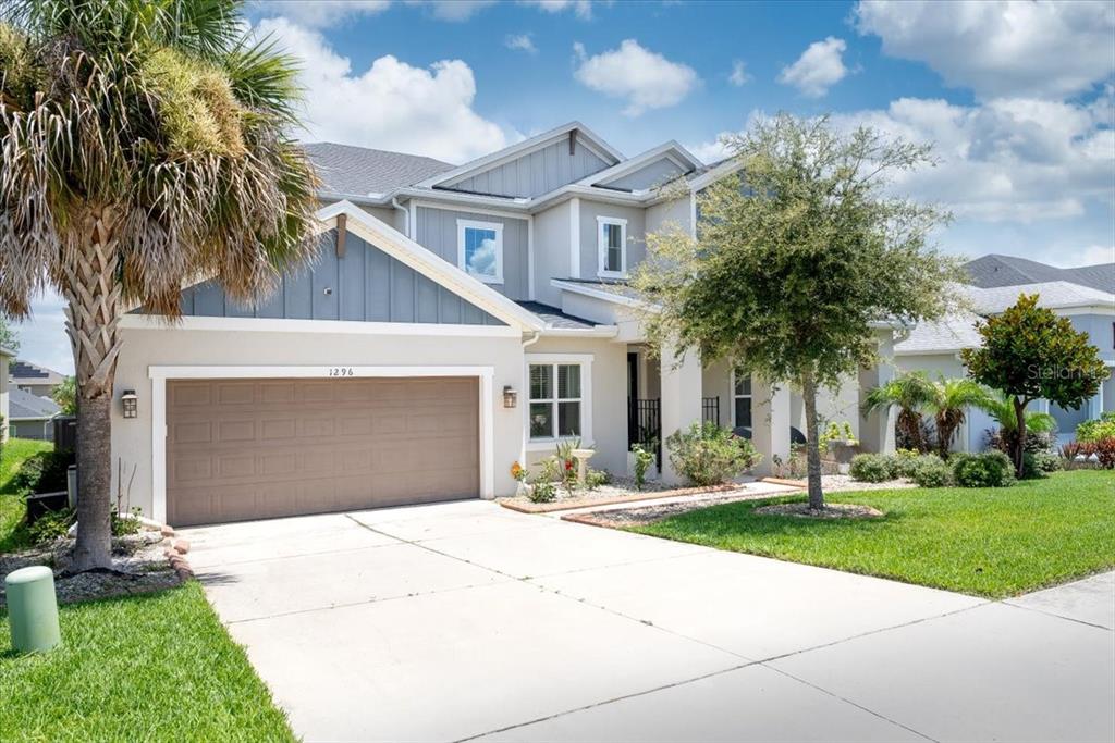 1296 Waterview Ridge Circle Apopka, FL 32703 - Photo 12 of 60 a front view of a house with a yard and trees