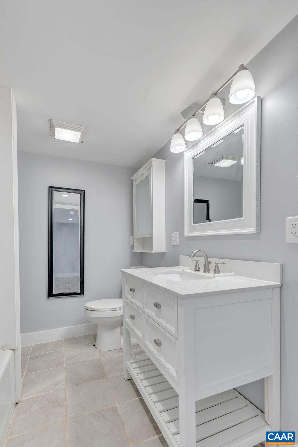 5668 Advance Mills Road Ruckersville, VA 22968 - Photo 51 of 56 a bathroom with a toilet sink and mirror