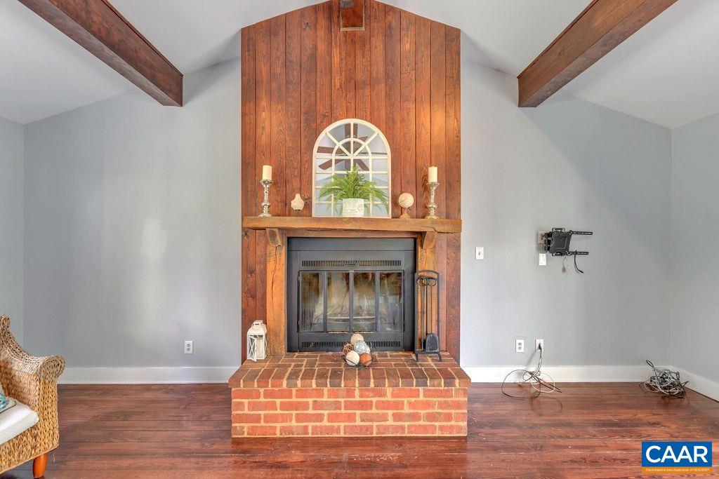 5668 Advance Mills Road Ruckersville, VA 22968 - Photo 9 of 56 a view of a livingroom with furniture wooden floor a fireplace and windows