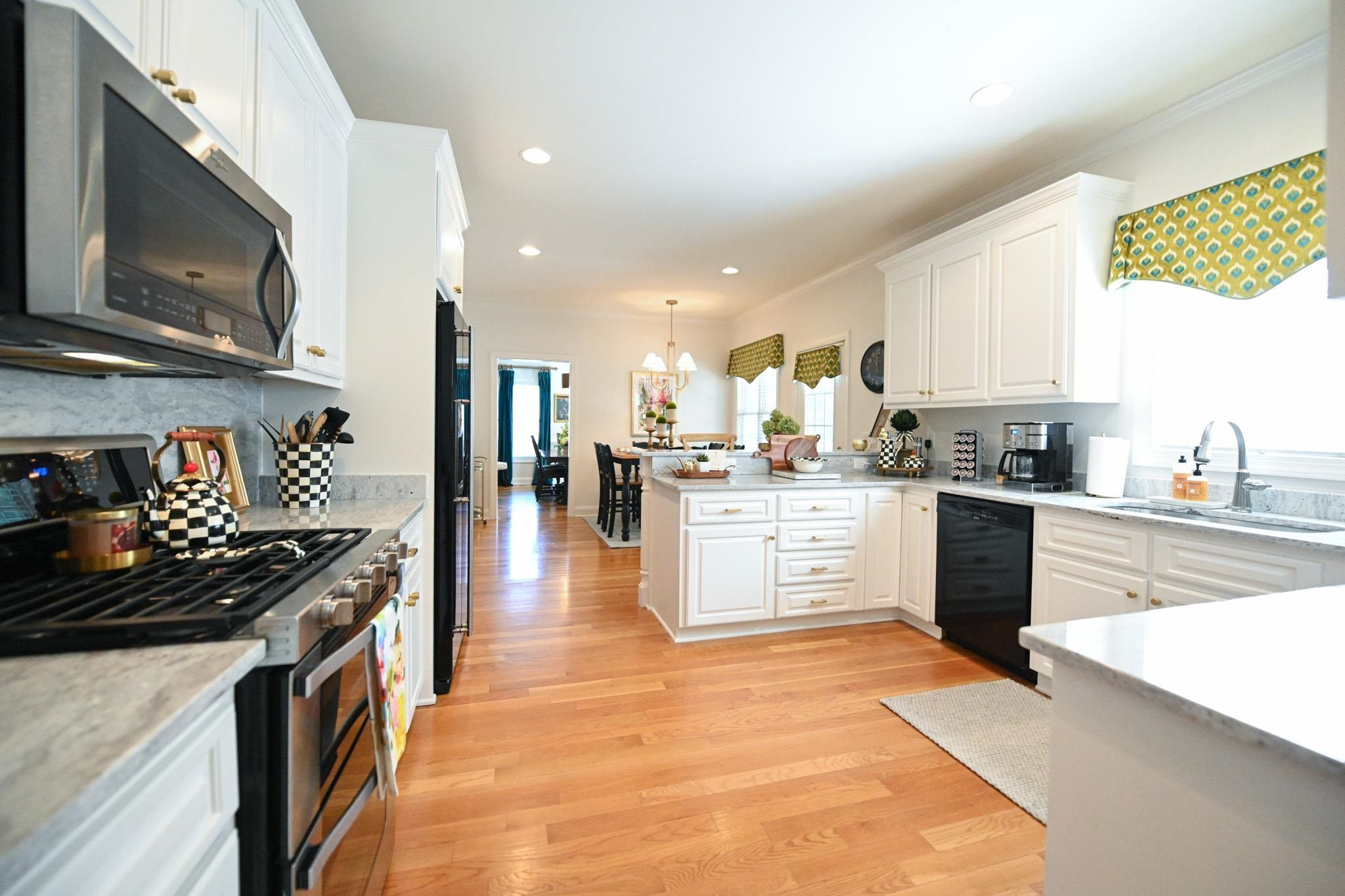 190 Pinecroft Drive Dunn, NC 28334 - Photo 24 of 51 a kitchen with stainless steel appliances kitchen island granite countertop a stove a sink and a microwave