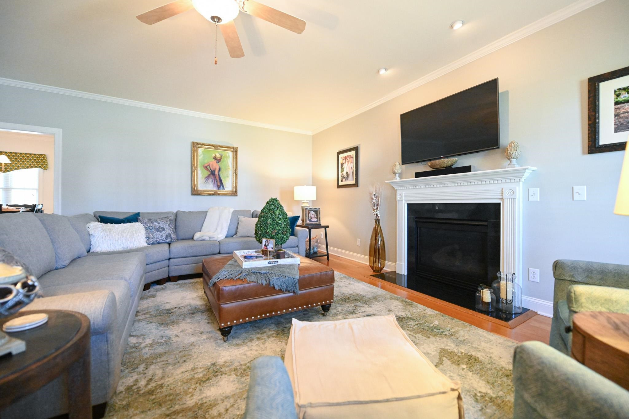 190 Pinecroft Drive Dunn, NC 28334 - Photo 45 of 51 a living room with furniture a fireplace and a flat screen tv
