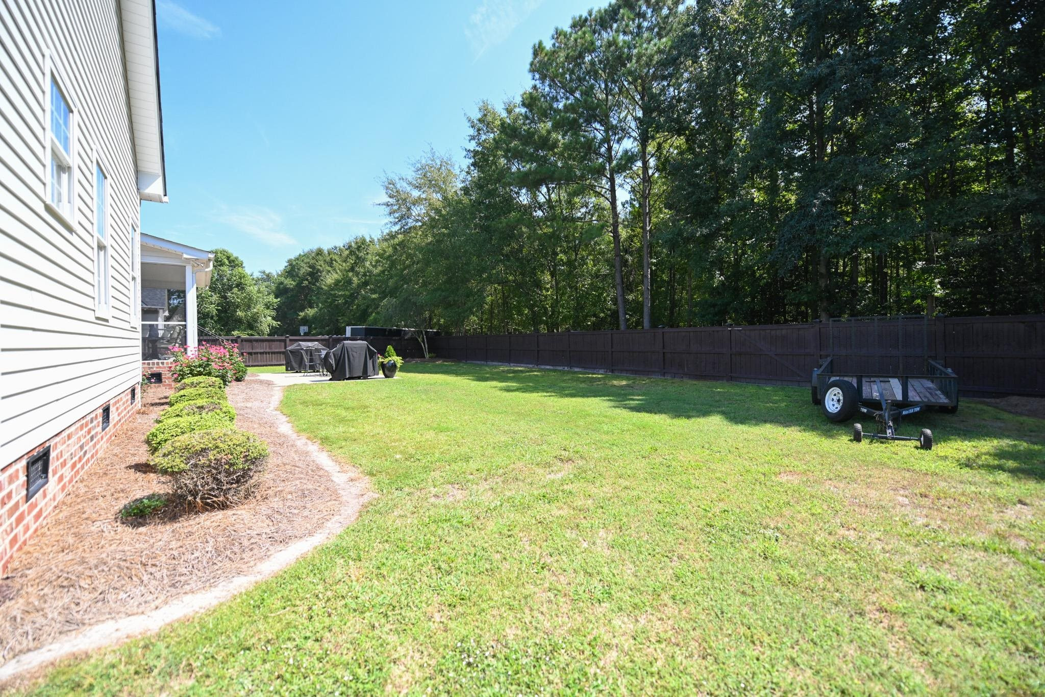 190 Pinecroft Drive Dunn, NC 28334 - Photo 5 of 51 a backyard of a house with lots of green space