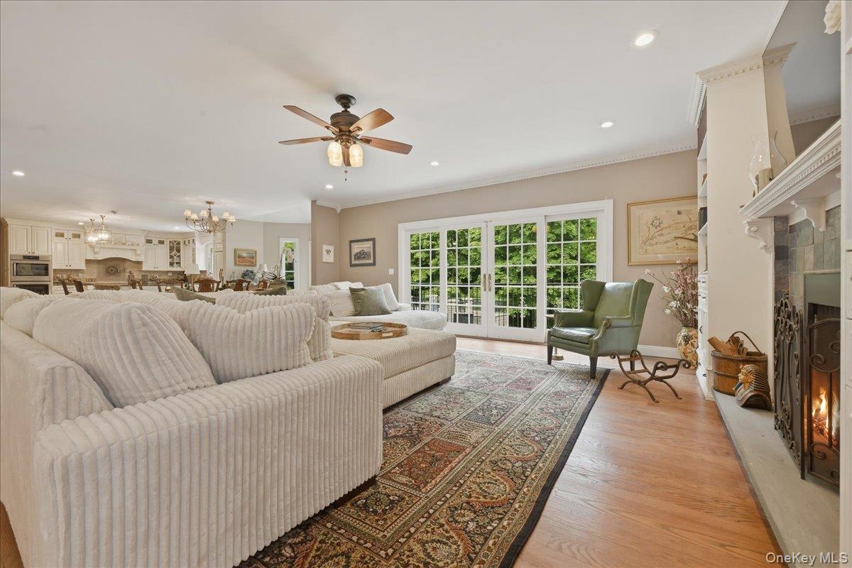 31 Cornwall Lane Sands Point, NY 11050 - Photo 11 of 49 a living room with furniture floor to ceiling window and a flat screen tv