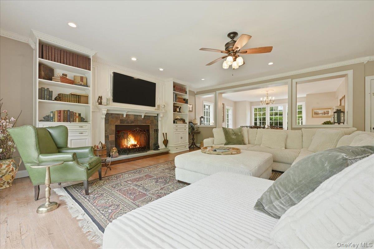 31 Cornwall Lane Sands Point, NY 11050 - Photo 12 of 49 a living room with furniture a flat screen tv and a fireplace