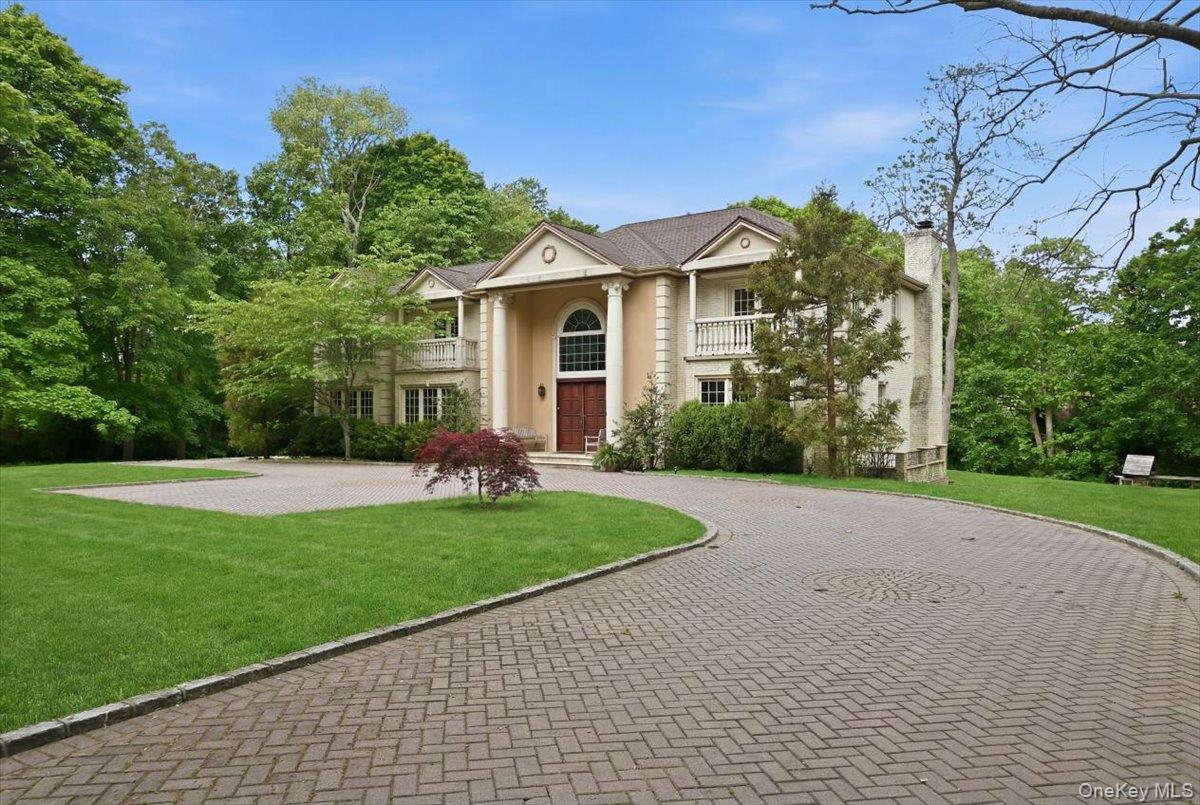 31 Cornwall Lane Sands Point, NY 11050 - Photo 2 of 49 a front view of a house with a garden
