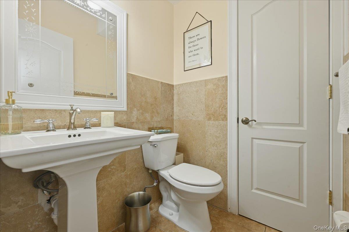 31 Cornwall Lane Sands Point, NY 11050 - Photo 23 of 49 a bathroom with a sink a toilet and shower