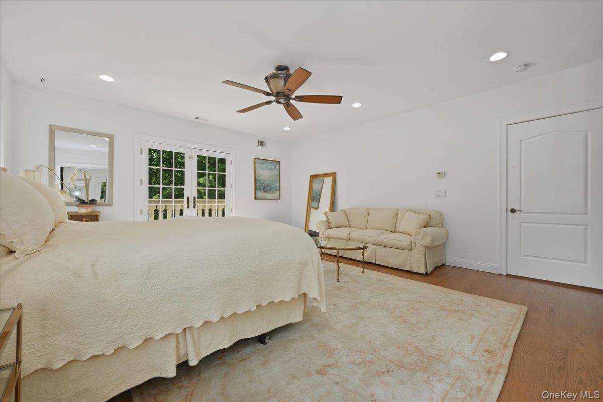 31 Cornwall Lane Sands Point, NY 11050 - Photo 28 of 49 a spacious bedroom with a bed and ceiling fan