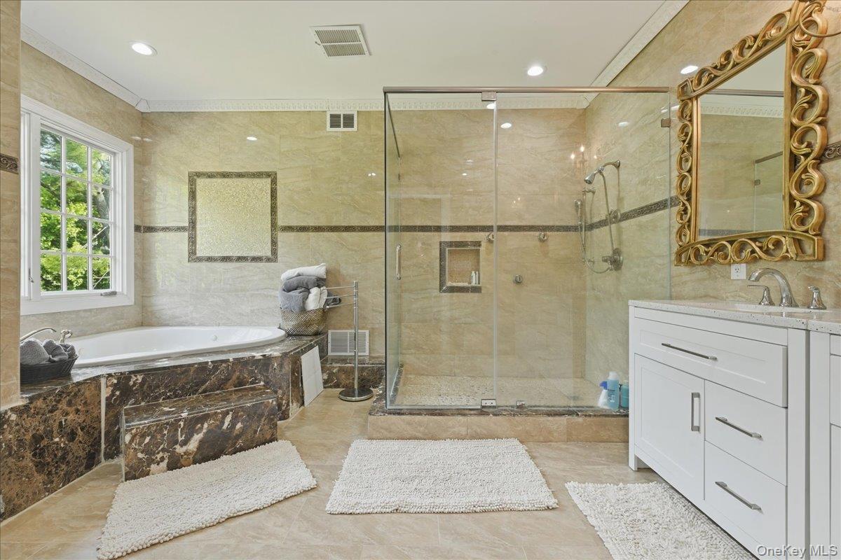31 Cornwall Lane Sands Point, NY 11050 - Photo 30 of 49 a bathroom with a sink a mirror and a shower