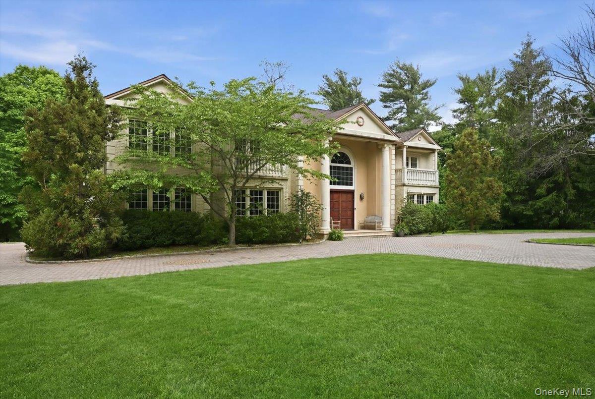 31 Cornwall Lane Sands Point, NY 11050 - Photo 3 of 49 a front view of a house with a garden