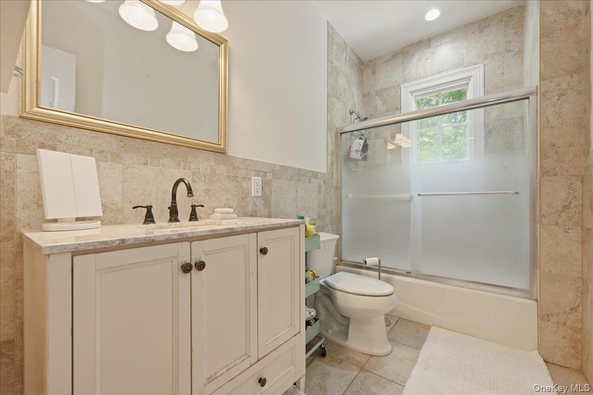 31 Cornwall Lane Sands Point, NY 11050 - Photo 33 of 49 a bathroom with a sink a toilet and shower