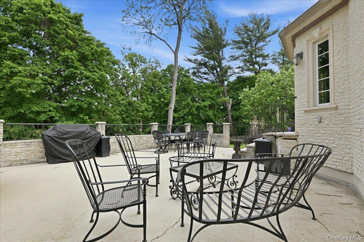 31 Cornwall Lane Sands Point, NY 11050 - Photo 38 of 49 a view of a patio with a table and chairs