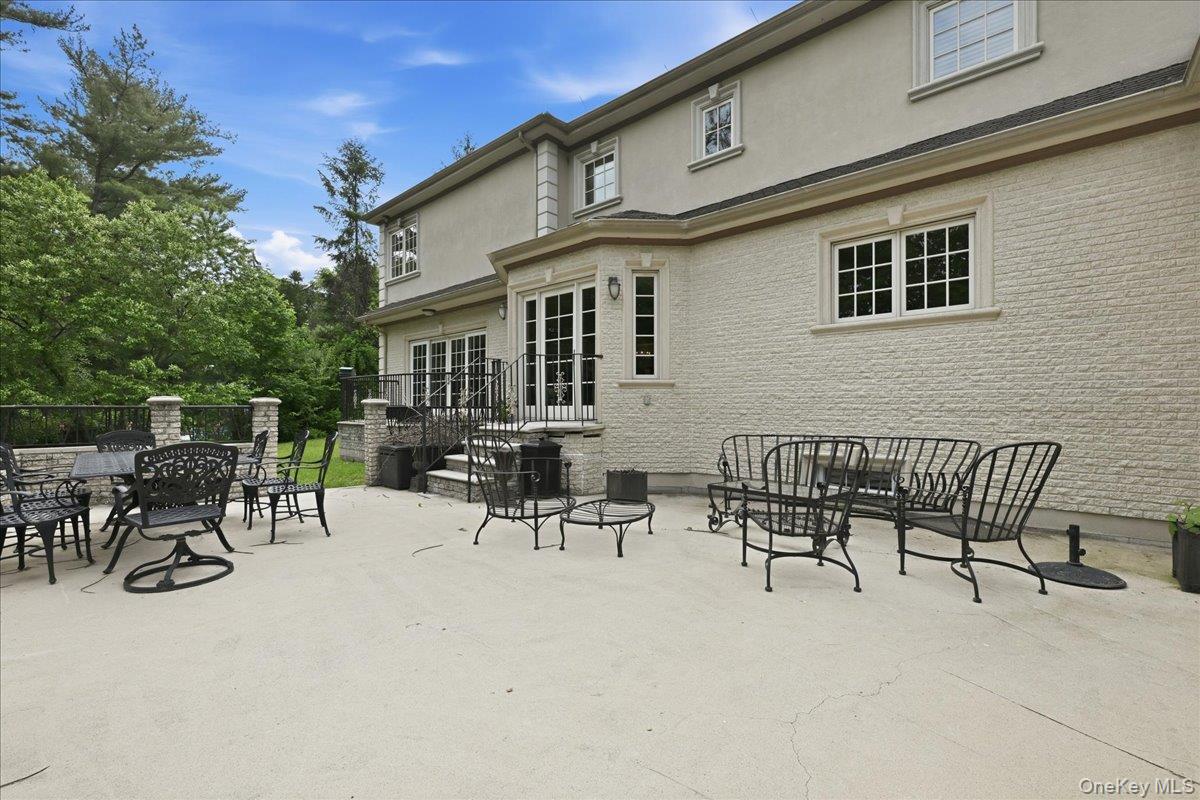 31 Cornwall Lane Sands Point, NY 11050 - Photo 39 of 49 a view of a patio with a table and chairs