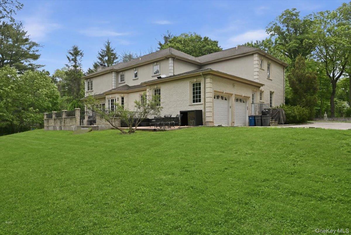 31 Cornwall Lane Sands Point, NY 11050 - Photo 42 of 49 a front view of house with yard and green space