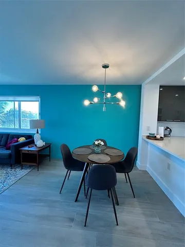 a bedroom with a bed table and chair