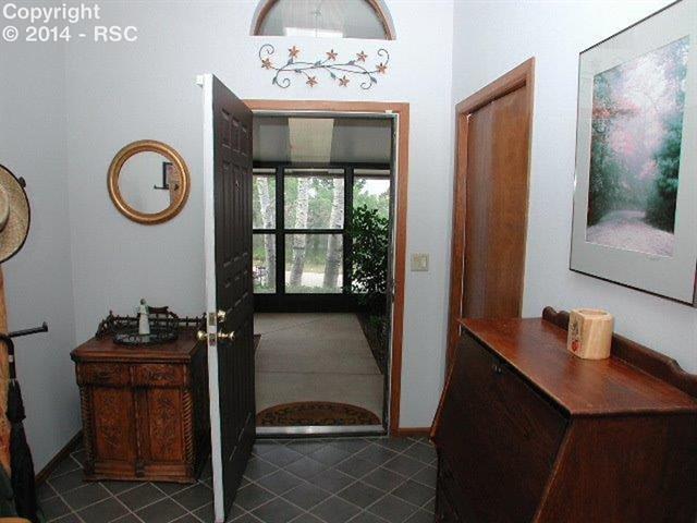 18105 Forest View Road Monument, CO 80132 - Photo 4 of 24 14x10 Vaulted Covered Entry with Tile Floor, Skylight, Coat Closet!