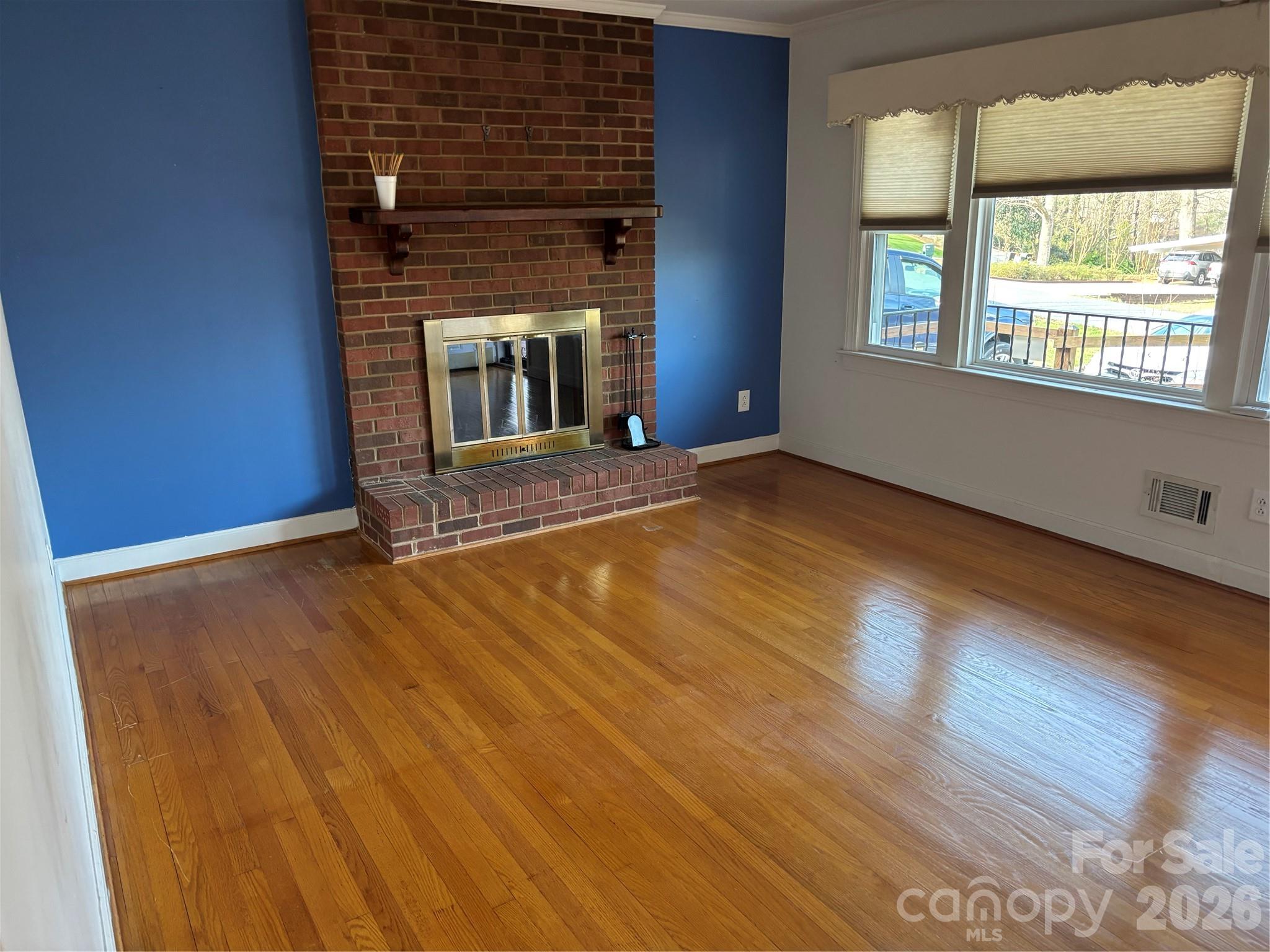 503 9th Avenue Southwest Conover, NC 28613 - Photo 13 of 39 a view of an empty room with wooden floor and a window
