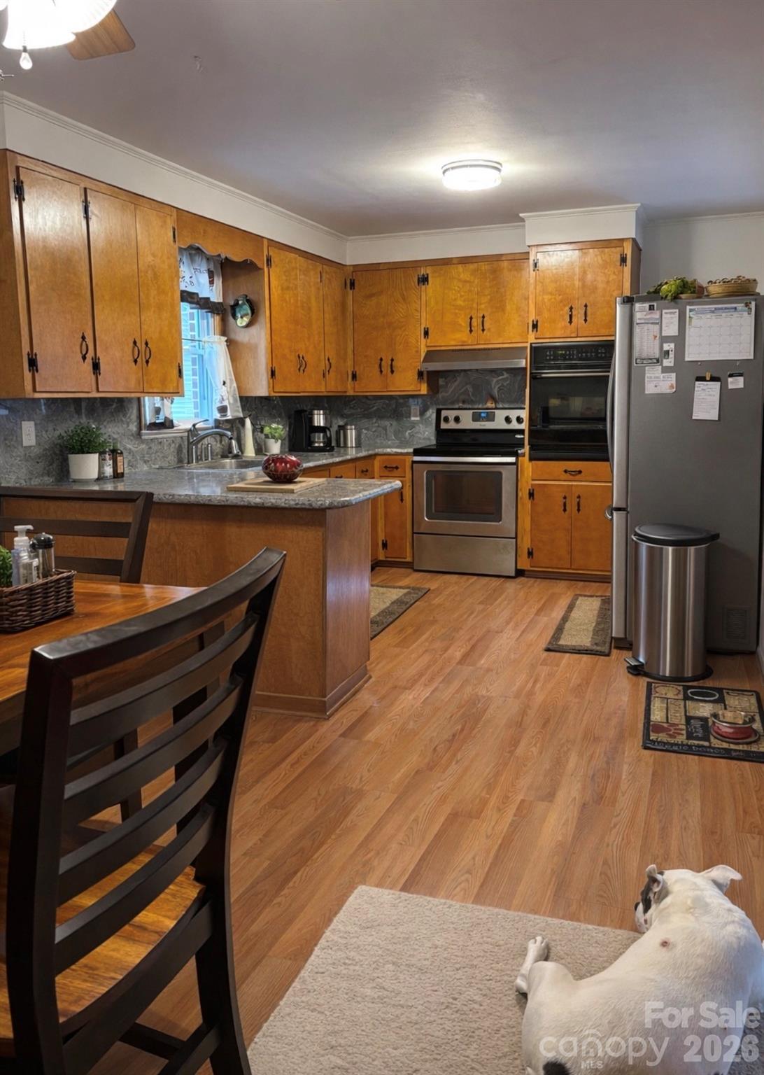 503 9th Avenue Southwest Conover, NC 28613 - Photo 16 of 39 a kitchen with stainless steel appliances kitchen island granite countertop a refrigerator a stove and a sink with wooden floor