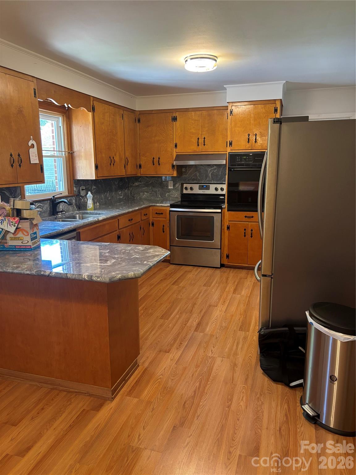503 9th Avenue Southwest Conover, NC 28613 - Photo 17 of 39 a kitchen with stainless steel appliances wooden cabinets and a counter top space