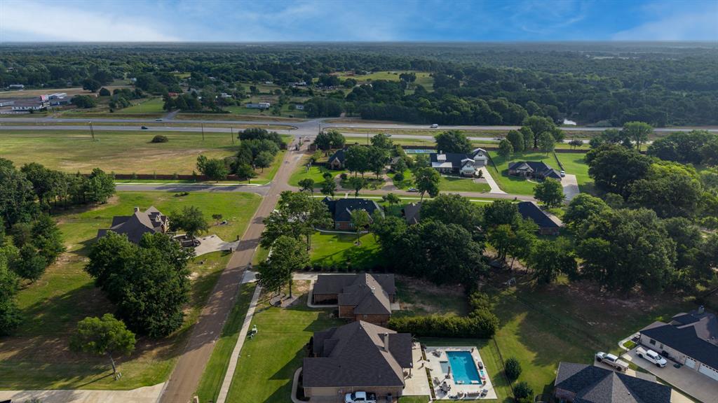 101 Lighthouse Lane Mabank, TX 75143 - Photo 34 of 40 Aerial perspective showcasing a residential community with mature trees and a structured road network