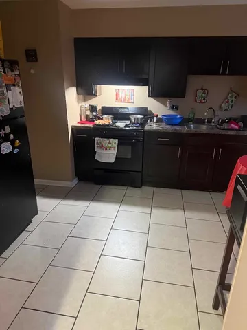 a kitchen with stainless steel appliances a sink stove and cabinets