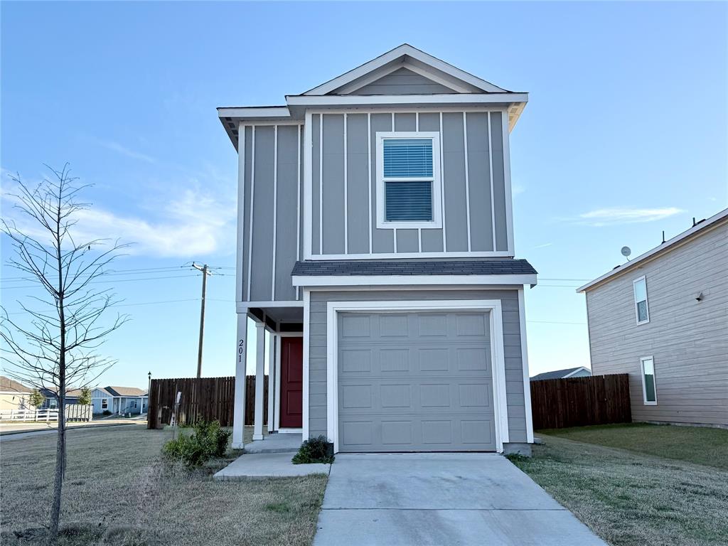 Modern two-story home with a clean, contemporary exterior featuring neutral siding, crisp white trim, and a single-car garage.