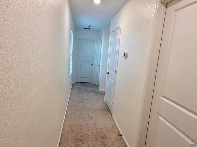 a view of a hallway with a wooden floor