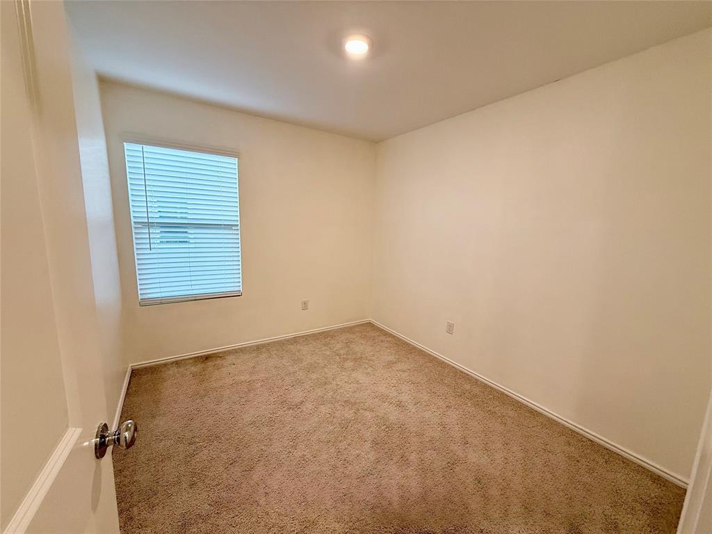 201 Boxberry Way Princeton, TX 75407 - Photo 16 of 24 Comfortable secondary bedroom featuring plush carpet, neutral tones, and a window that provides natural light. The versatile space is ideal for a bedroom, home office, or guest room.