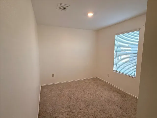 a view of an empty room and window