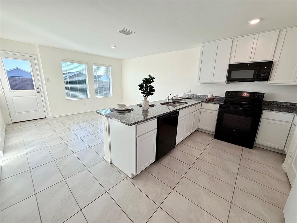 201 Boxberry Way Princeton, TX 75407 - Photo 6 of 24 a kitchen with stainless steel appliances granite countertop a sink and a stove